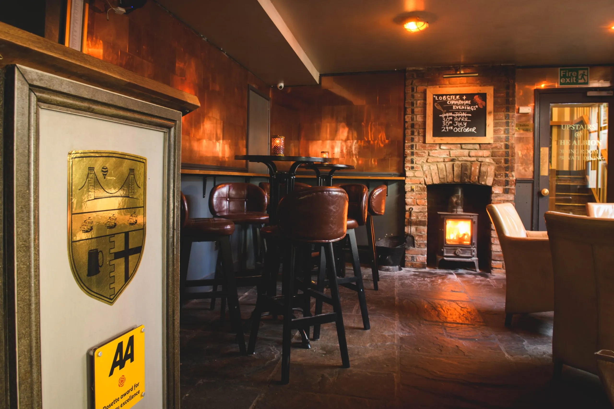 The Albion Bristol Bar Area With Wood Burning Stove Leather Bar Stools And Copper Wall Boyces Avenue Clifton Village